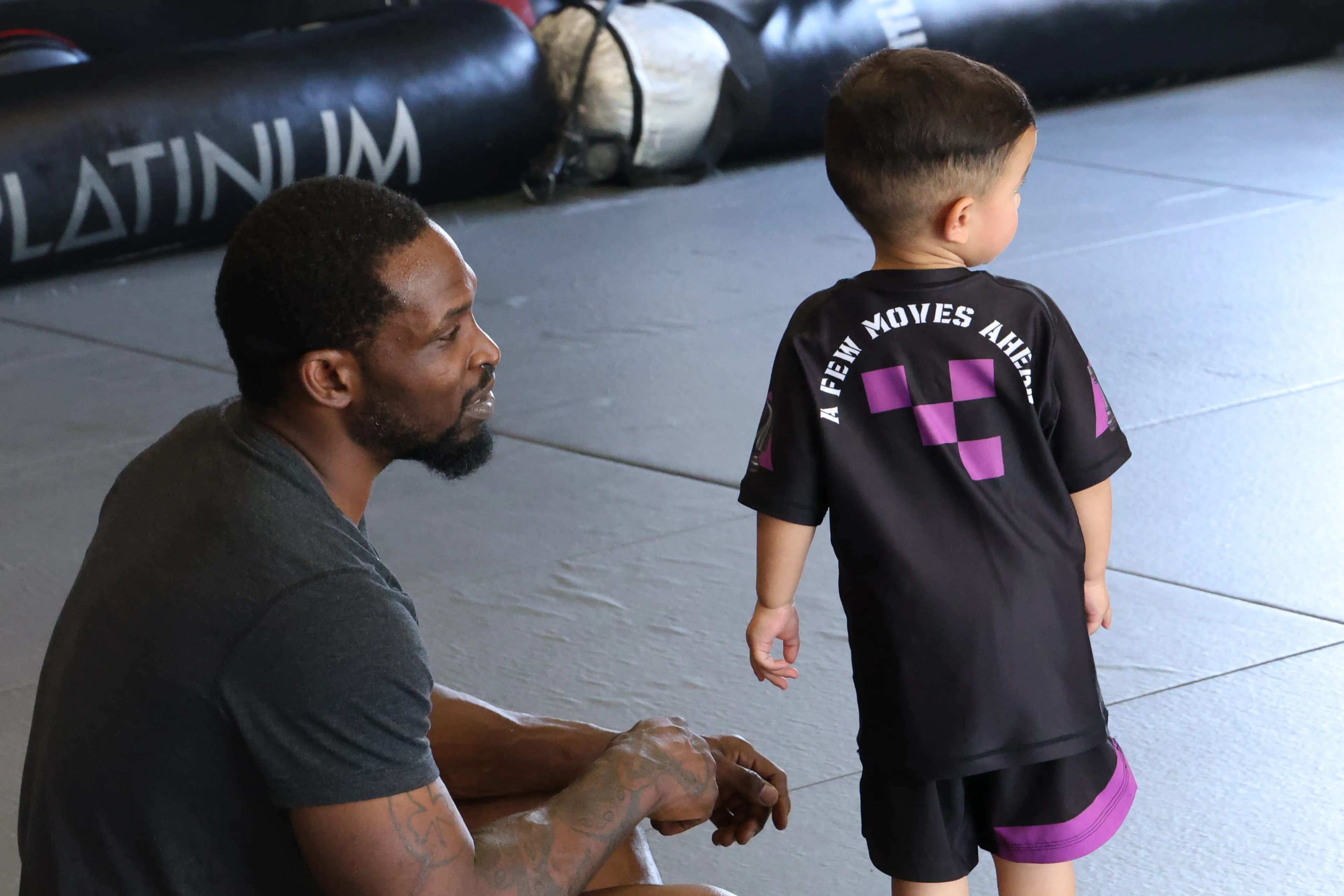 Small kids martial arts class with instructor demonstrating techniques