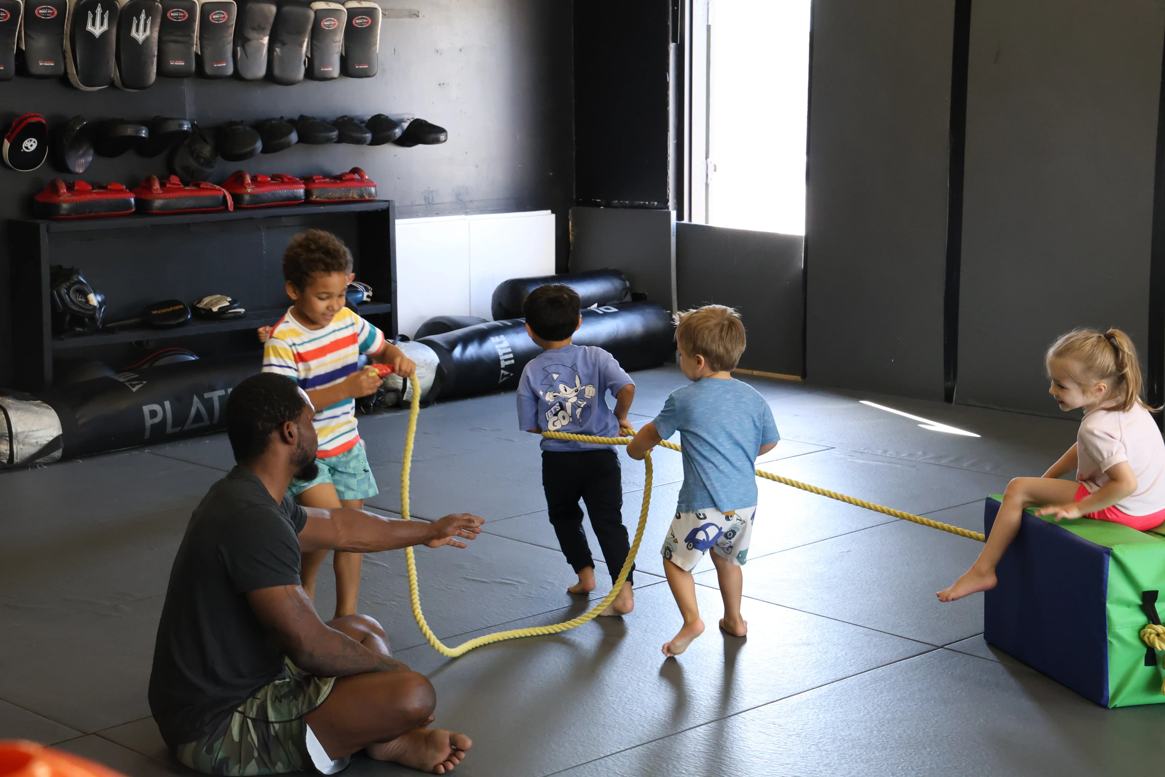 Fun team activity during a kids martial arts class with instructor leading the group