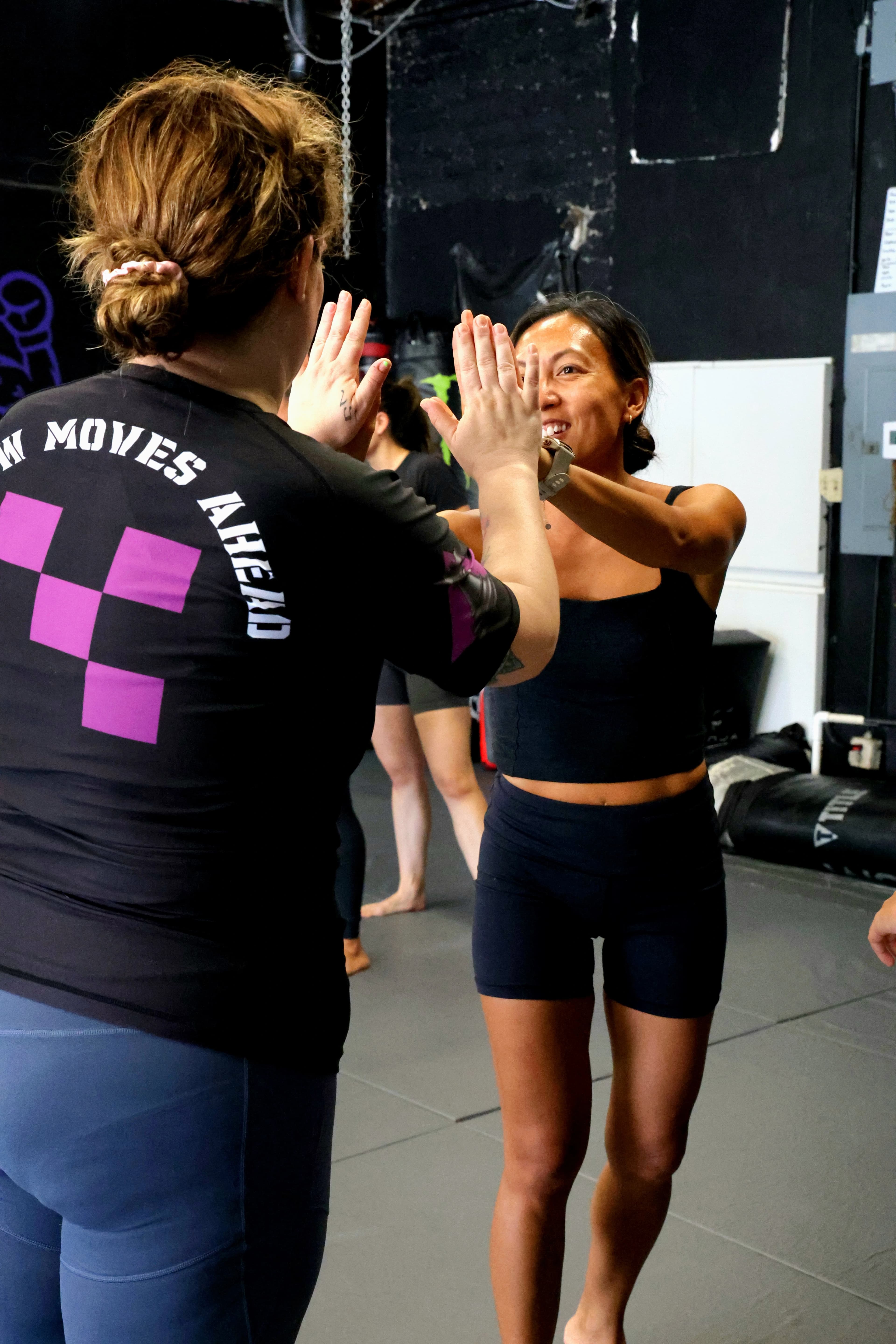 Women's self-defense students practicing techniques together