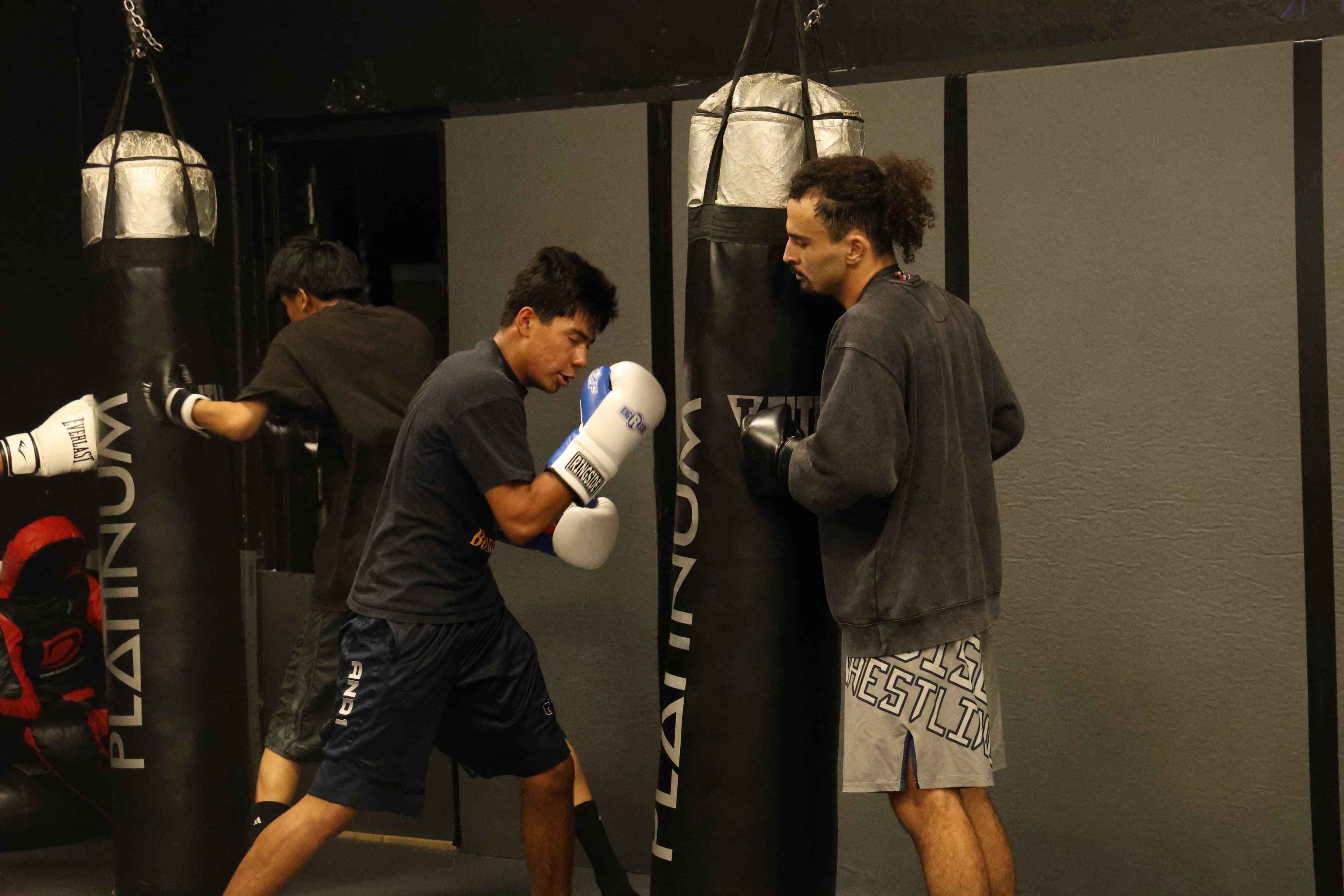 Students practicing boxing combinations and pad work