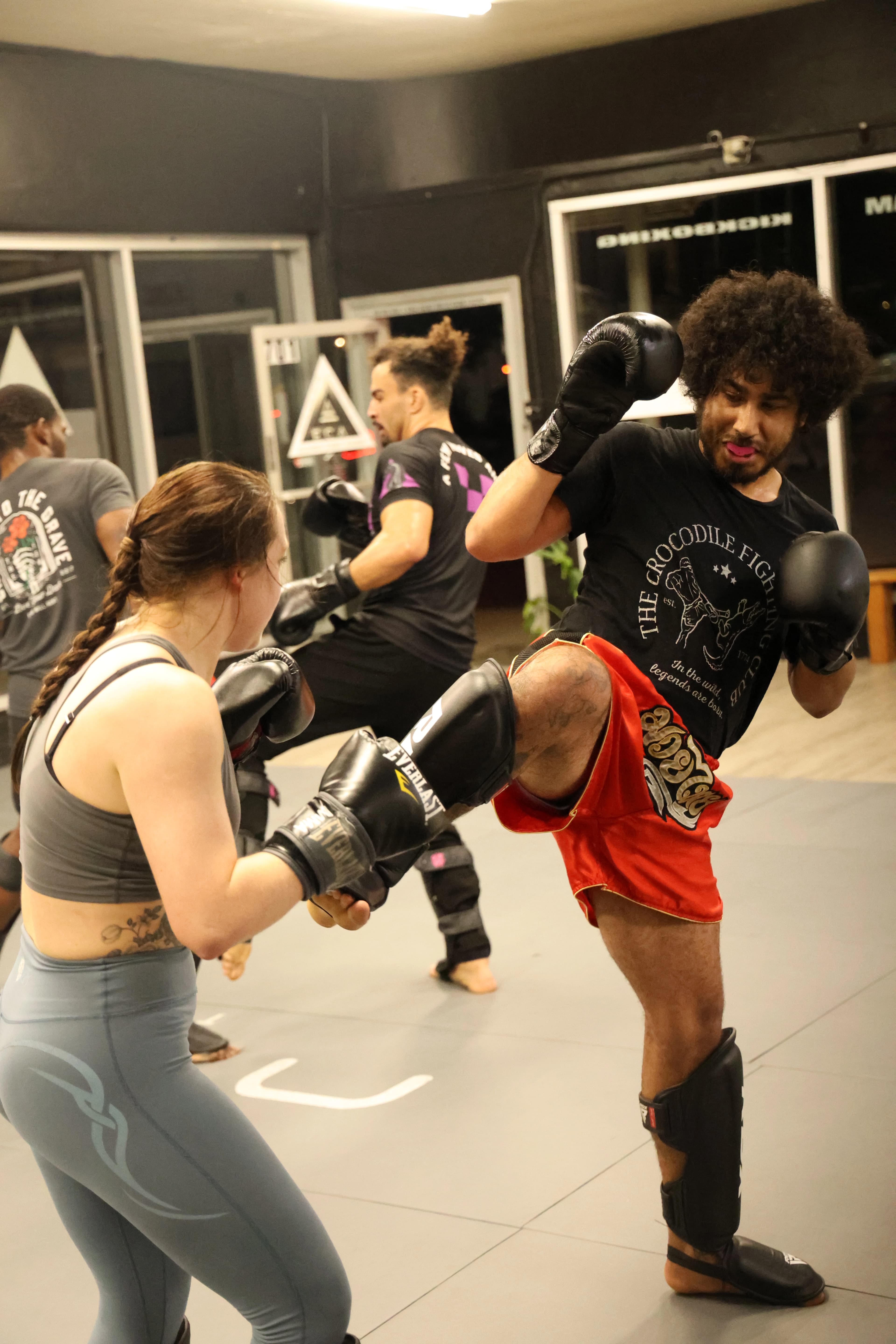 Students practicing Muay Thai striking combinations during class