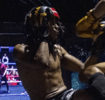Coach Isaac Mwereru demonstrating kickboxing technique