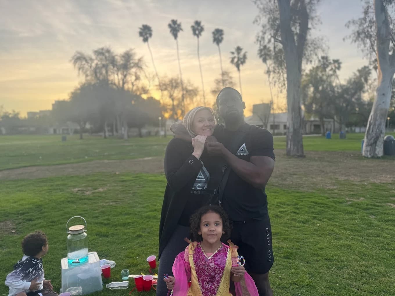Family-owned martial arts academy owners and students together