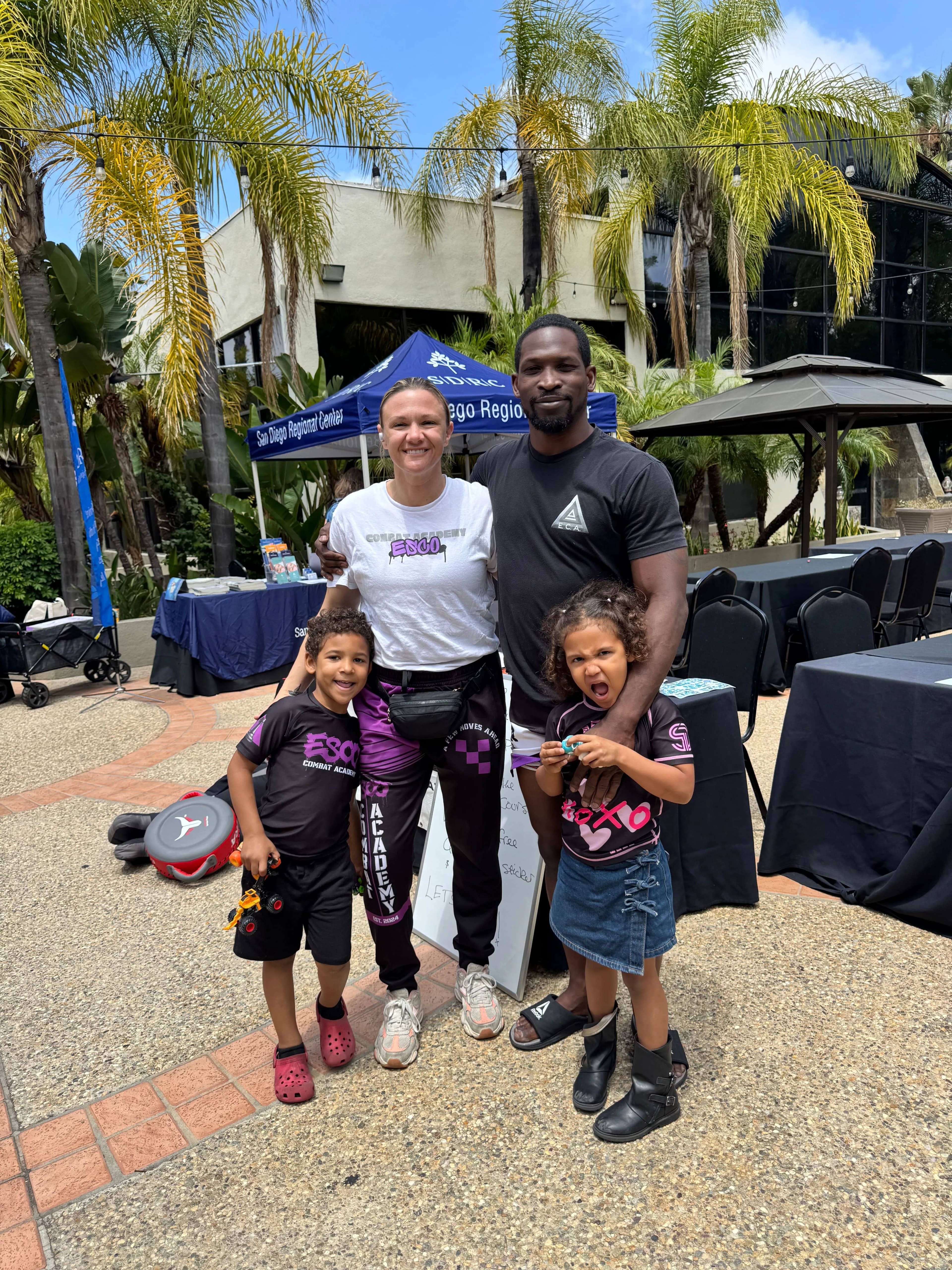 Family-owned martial arts academy owners and students together
